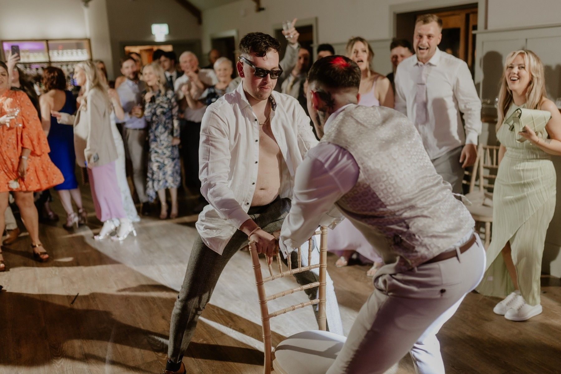 Photo of a wedding party playing musical chairs